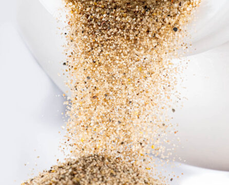 High purity silica sand falling from a container to show individual particles